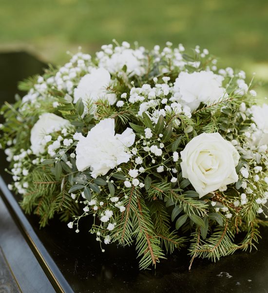 Big Bouquet on Coffin Big round bouquet consisting of rose and fur tree on black wooden coffin
